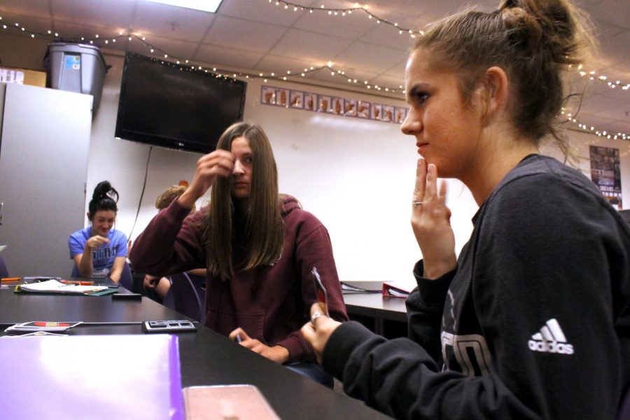 Port Neches-Groves sophomore Samantha Tentrup gives the sign for the word ‘color’ as she and classmates play a game of UNO during Mrs. Cozad’s American Sign Language class. Students playing the game could only communicate through sign language.