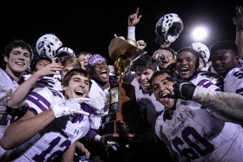 The varsity football team celebrates with the Bum Phillips Trophy after winning the annual Mid-County Madness football game against Nederland, 27-21, on Friday, Nov. 8, 2019 at Bulldog Stadium.