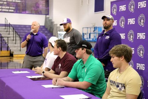 Port Neches-Groves head coach Brandon Faircloth welcomes the crowd into the Indians competition gym before the start of Wednesday afternoons college signing ceremony in Port Neches.
