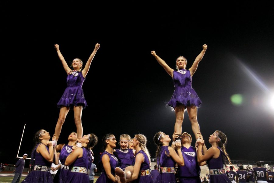 The varsity cheer team performs stunts during the Indians home game with Dayton on Oct. 18, 2019.