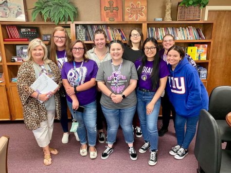 Asst. Superintendent Dr. Brenda Goates Duhon is presented with her copy of the recently published 2018-19 War Whoop yearbook on Sept. 14, 2019. Several of this year’s staff are returning advanced journalism students. Some will help produce the book for the first time. 