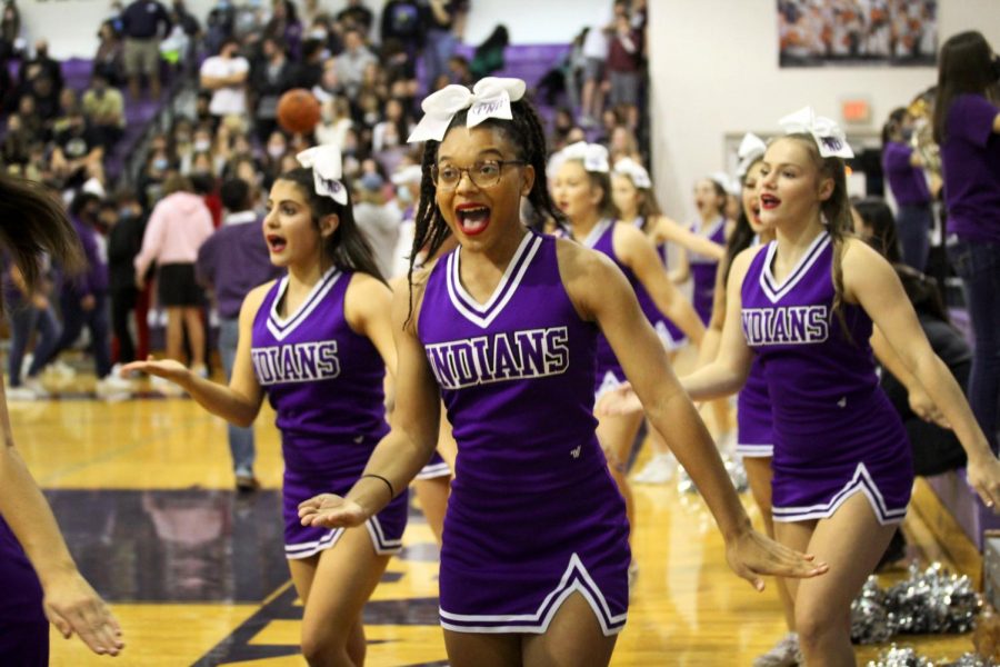 The varsity cheerleaders perform the fight song routine as the band plays Cherokee during the Indians basketball game with Mid-County rival Nederland on Friday, Jan. 15.