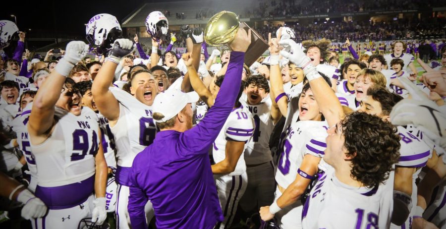 The varsity football team erupts in celebration as head football coach Jeff Joseph raises the state semifinal trophy following the game with Liberty HIll at Legacy Stadium in Katy on Friday, Dec. 9. PNG won, 42-14, to advance to its first state title game since 1999. (Emily Mire/NDN Press)