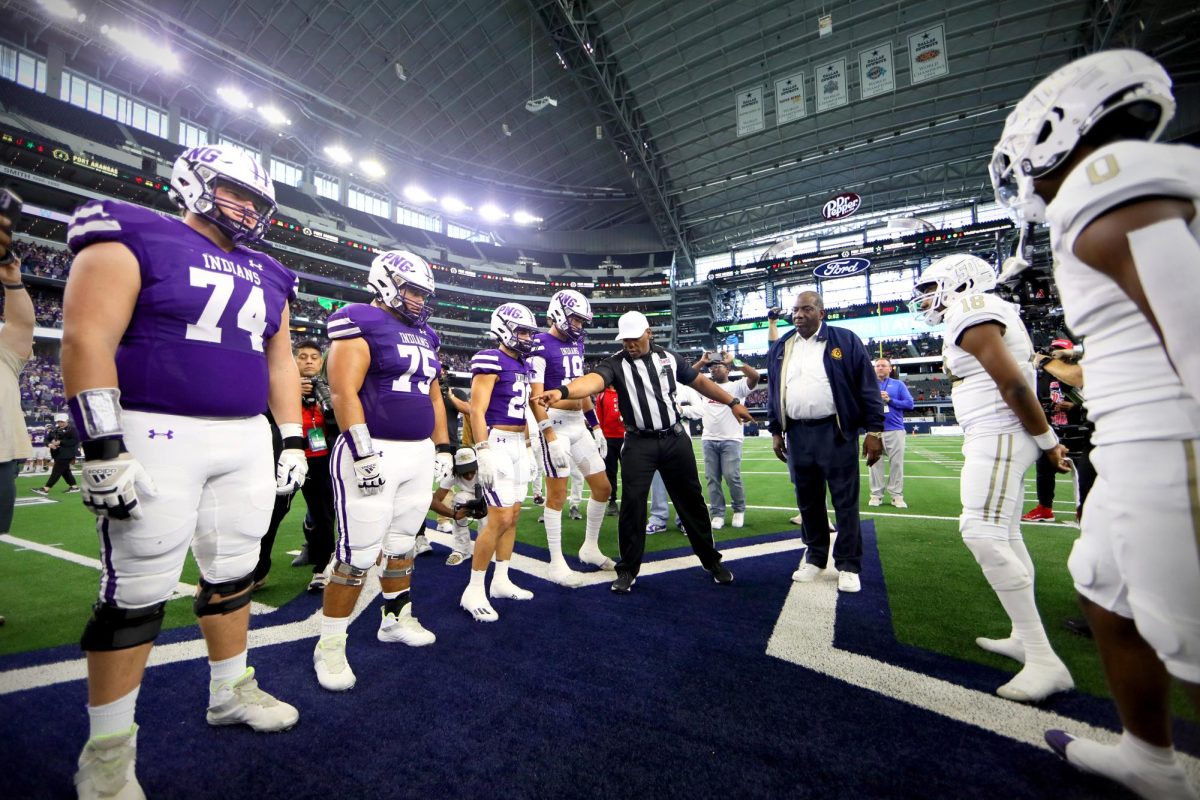 Varsity football captains Jackson Christian (25), Mario Miguel (24), Chase Johnson (24) and Shea Adams (24) listen as the referee gives instruction prior to the coin flip at the Class 5A Division II state final game with South Oak Cliff in Saturday, Dec. 16 at AT&T Stadium in Arlington. 

PNG won, 20-17, giving the team its first state title since 1975. (Annabella Molina/NDN Press)
