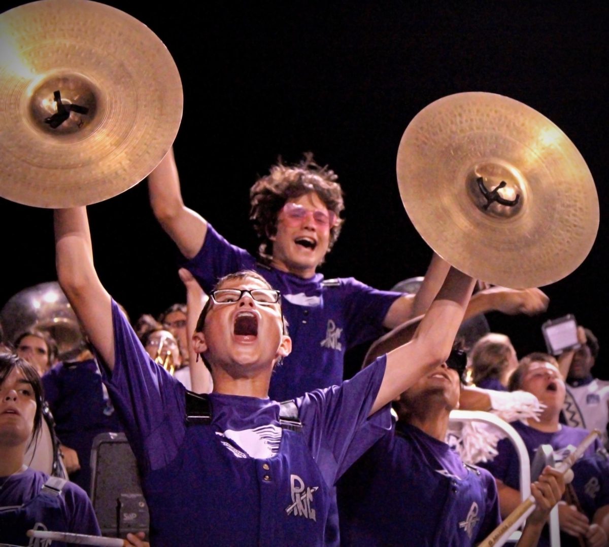 As the game with West Orange-Stark nears the end of regulation, percussionist Landon Barrett ('27) exults as the team nears the end zone to set up a game-tying score on Friday, Sept. 8. PNG scored on the next play, tying the game and forcing overtime where the team eventually won, 26-20. (Kristyn Vu/NDN Press)