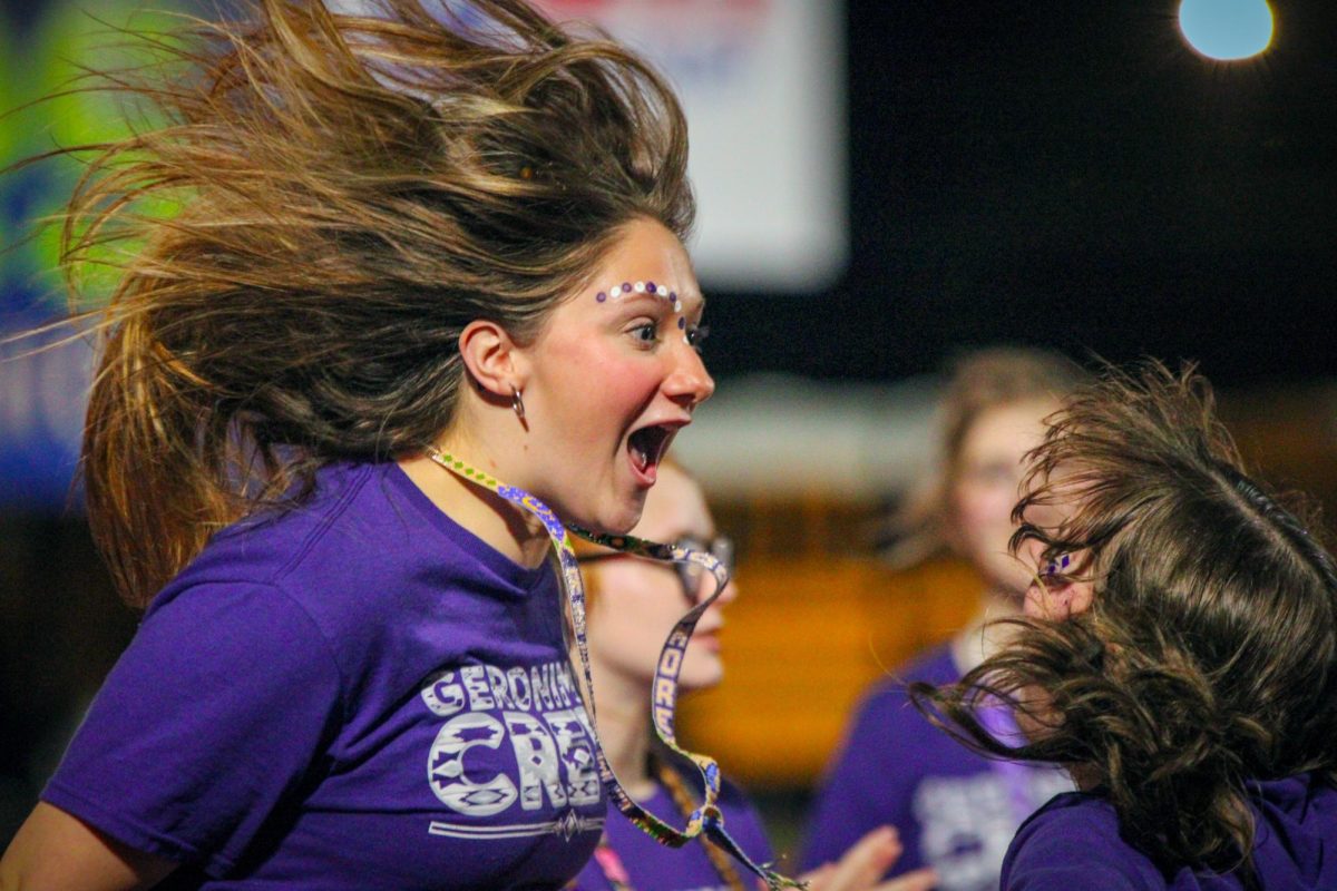 After watching the team play from behind the majority of the night — and with her hair aflutter, G-Crew member Kendyll Frioux ('25) turns and leaps toward Arden Vandehoef ('25) as the Indians score twice in the fourth quarter to cut Nederland's lead to 3 points, 30-27, on Friday, Oct. 18, 2024. 