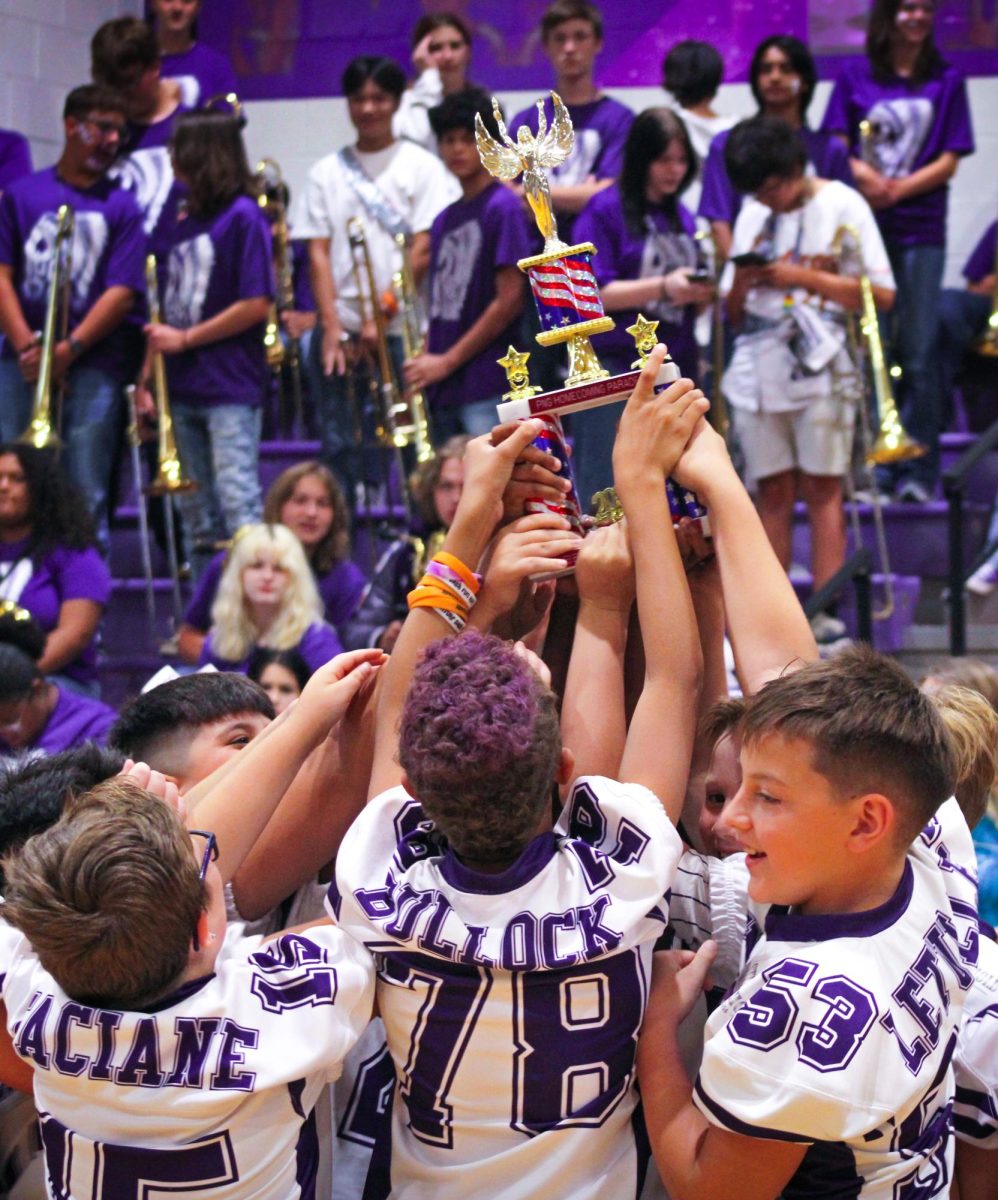 Members of the PNGYFA Junior White Football team hoist a trophy for the overall winners of this year's Homecoming parade during the pep rally on Friday, Sept. 28, 2024. The team got together and made a Pirates of the Caribbean ship out of cardboard boxes and paint, they even used smoke bombs and confetti. Though the team went winless on the season, they never quit and wanted to put in a lot of effort for this parade to show their school spirit. What made this win even more special for them, according to Team Mom, Michelle Ansel, is that it was their first pep rally to go to. (Brynna Vice/NDN Press)