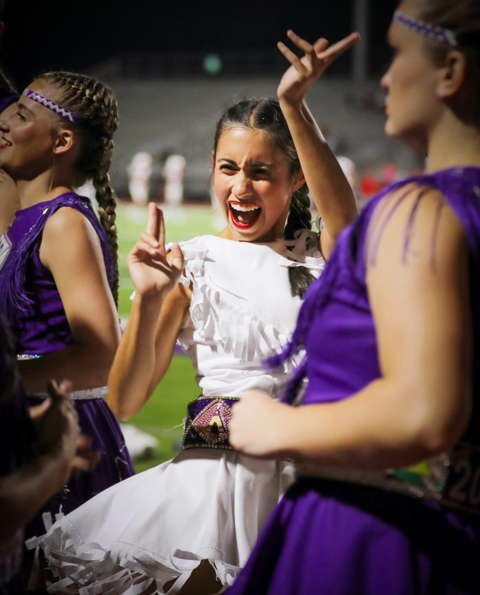 Following the Homecoming halftime festivities, varsity twirler Paulina Torres ('25) dances to the beat being played by the drum line as they perform in front of the student section in the third quarter of the game with Splendora on Friday, Oct. 11, 2024. 