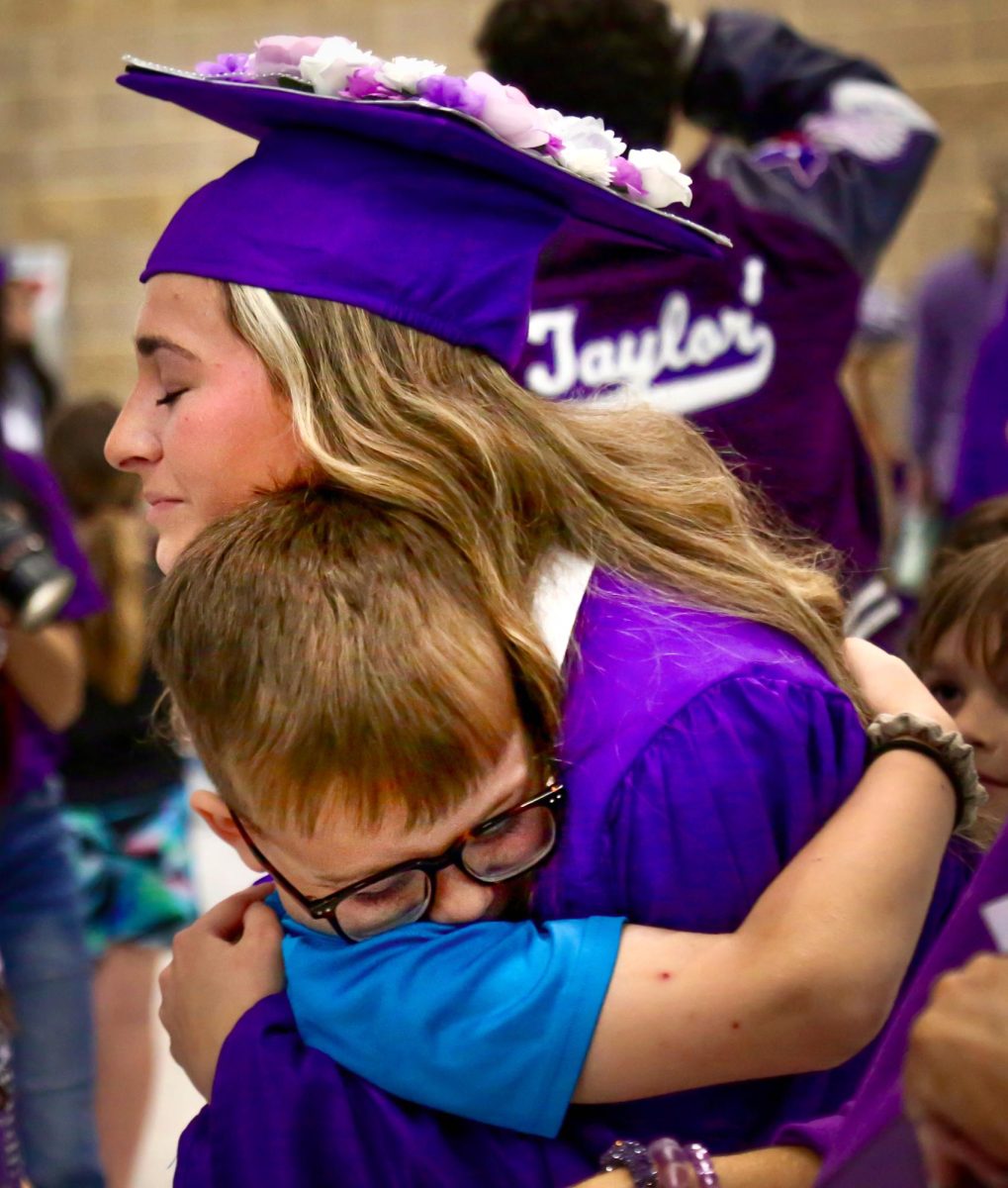 Emerey Riley (‘24) gives an emotional embrace to one of her students during the Senior Walk-Thru ceremony Friday, May 17, 2024 at Groves Primary. A peer tutor at the school, Emerey was greeted by a throng of her students, who cheered and greeted her and made signs with Emerey’s face in it as she walked through. 

According to Emery, the embrace was the moment she realized she would not be seeing her students together anymore. 

The morning ended after the students toured the four elementary schools and two middle schools across Port Neches and Groves. Students were then treated to a pizza party and cake back at the high school. 

It was a change from past tours, but remained an opportunity to reconnect with former teachers and peer tutors to embrace their classes for a final time before graduation. (Jozlyn Oglesbee/NDN Press)