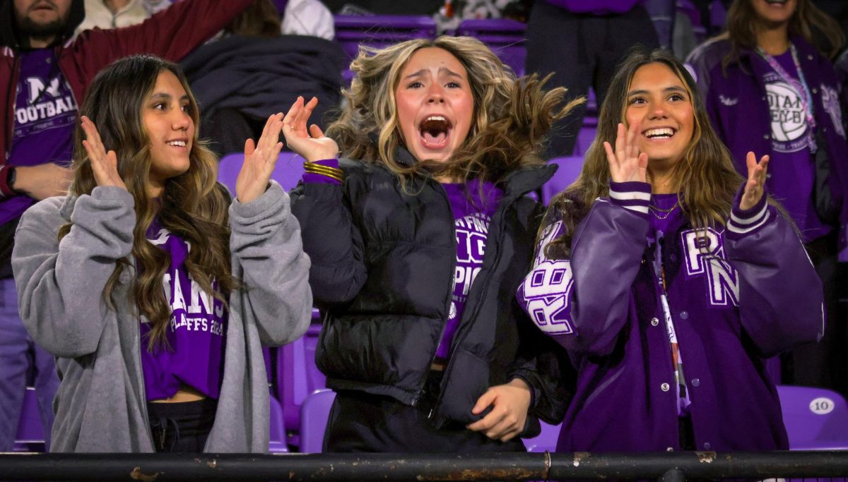 As the go-ahead touchdown was scored, Ally Hecker ('25), shrieks while friends and fellow seniors Kayleigh Wardlow, right, and Alexis Wardlow, left, applaud during the Class 5A-II regional round playoff game with Texas High at Northwestern State University in Natchitoches, Louisiana on Friday, Nov. 29, 2024. The score helped give the Indians a 31-28 lead with 4:04 remaining. PNG would block a game-tying field goal on the next Texas High drive to seal the victory. "That was exhilarating," Hecker said, "I don't know how else to describe it." (Bill To/NDN Press)