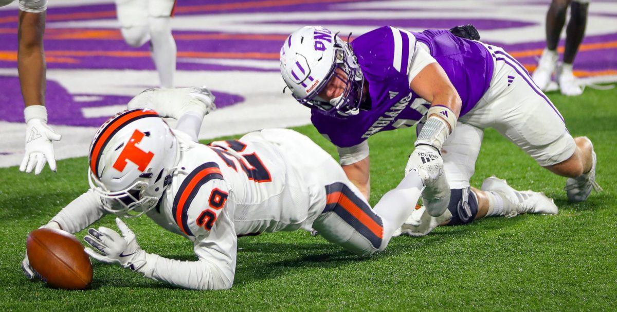 After fumbling a pass, running back Layden Williams ('25) grabs onto the ankle of Texas High's Blake Banks ('26) as Banks recovers the ball to stop PNG's two-point conversion with 6:49 left in the third quarter of the Class 5A-II regional round game at Northwestern State University in Natchitoches, Louisiana. PNG trailed 18-21 as it cut into the Texas High lead. (Izzy Zeig/NDN Press)