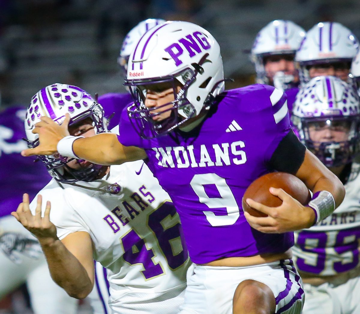 Quarterback Connor Bailey ('26) uses a stiff-arm block to keep a defender at bay as the Indians take on the Montgomery Bears on Friday, Nov. 1, 2024. PNG outlasted Montgomery, 37-31, winning its final scheduled home game of the season. (Jozlyn Oglesbee/NDN Press)