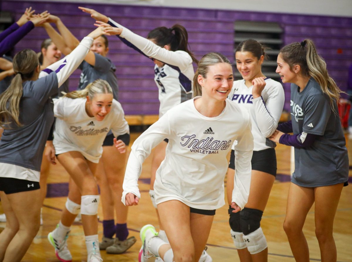Varsity volleyball player Kelby Marsh ('26) smiles as she takes the court for the team's first scrimmage of the season with West Brook on Tuesday, Aug. 5, 2025. The volleyball team is always the first of the school sports to compete and regularly does this ahead of first day of school, scheduled this year for Thursday, Aug. 14. (Payton Bryan/NDN Press)